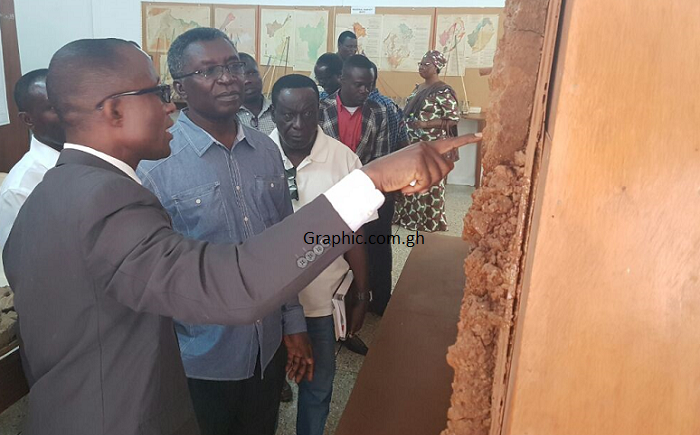 Dr Eric Owusu Adjei(2nd left),Scientific Secretary, Soil Research Institute, Kwadaso Agric College (KAC), explaining a point to Prof Frimpong Boateng(3rd left), the Minister of Environment Science Technology and Innovation, during a visit to the Soil Laboratory at the KAC in Kumasi.